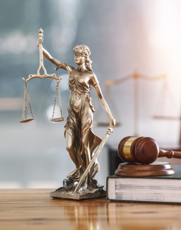 Legal and law concept. Statue of Lady Justice with scales of jus Legal and law concept. Statue of Lady Justice with scales of justice and wooden judge gavel on wooden table. Panoramic image statue of lady justice.